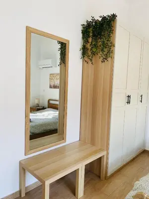 a mirror and a wooden bench in a room at Azure House in Athens