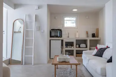 a living room with a white couch and a table at Astrid in Athens
