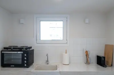 a kitchen with a microwave and a window at Astrid in Athens