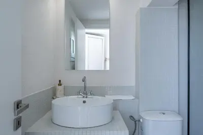 a white bathroom with a sink and a toilet at Astrid in Athens