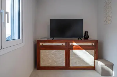 a flat screen tv sitting on top of a cabinet at Astrid in Athens