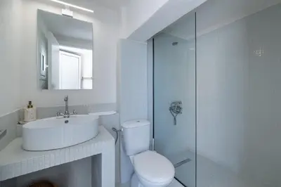 a bathroom with a toilet and a sink and a shower at Astrid in Athens