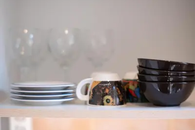 a shelf with plates and cups on it at Luxury suites XiangBaLa Glyfada in Athens