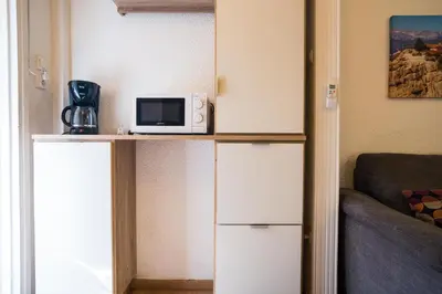 a microwave sitting on top of a counter in a room at Luxury suites XiangBaLa Glyfada in Athens