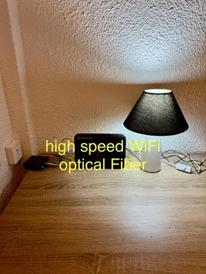a lamp on a ceiling with the words high speed wifi original fiber at Luxury suites XiangBaLa Glyfada in Athens