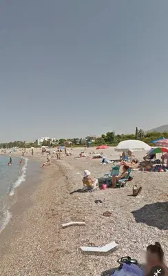 a group of people sitting on a beach at Luxury suites XiangBaLa Glyfada in Athens