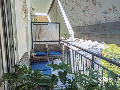 a balcony with two chairs and plants on a balcony at Kremou Studio in Athens
