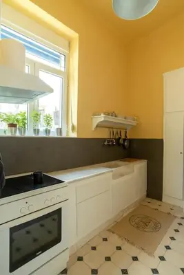 a kitchen with a stove and a window at Casanova94 Guesthouse in Piraeus