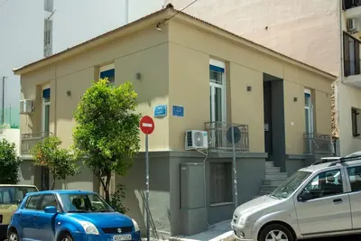 a blue car parked in front of a building at Casanova94 Guesthouse in Piraeus