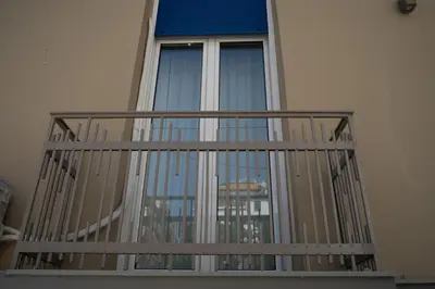a balcony with a view of a window at Casanova94 Guesthouse in Piraeus