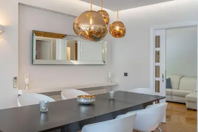 a dining room with a table and chairs and a mirror at The HostMaster Luminous Elite Estate in Athens