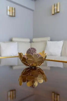 a vase with flowers on a table in a room at The HostMaster Luminous Elite Estate in Athens