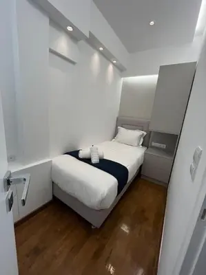 a small white room with a bed in it at The HostMaster Luminous Elite Estate in Athens