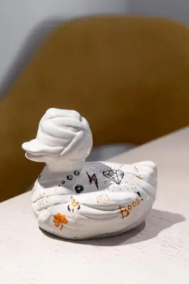 a small white ceramic figurine of a chef at Varkiza Sea Front Residence by First Class Properties in Vari