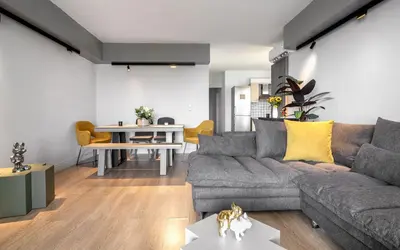 a living room with a couch and a table at Varkiza Sea Front Residence by First Class Properties in Vari