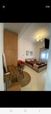 a bedroom with a bed and a table and a desk at ANAFIS STUDIO in Athens