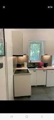 a kitchen with white cabinets and a sink and a window at ANAFIS STUDIO in Athens