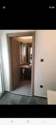 a doorway to a bathroom with a sink and a mirror at ANAFIS STUDIO in Athens