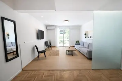 a living room with a couch and a table at Modern flat close to the beach-ground floor in Athens