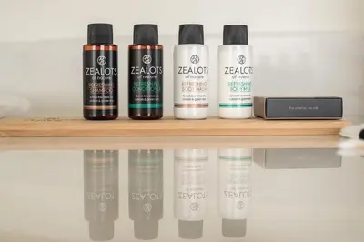 a shelf with four bottles of hair products on it at Varkiza Riviera in Varkiza