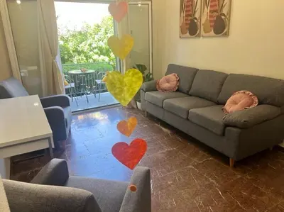 a living room with a couch and hearts on the floor at LP appartment athens in Psikhikón