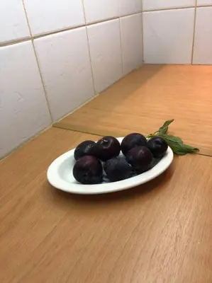 a plate of olives on a wooden table at LP appartment athens in Psikhikón