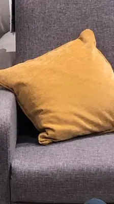 a yellow pillow sitting on a gray couch at LP appartment athens in Psikhikón