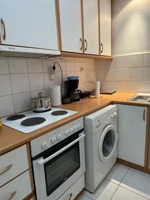 a kitchen with a stove and a washing machine at LP appartment athens in Psikhikón