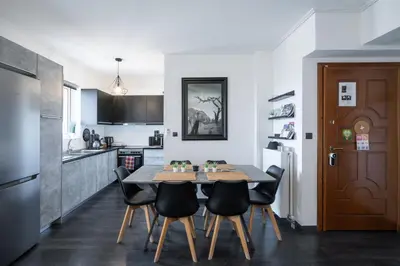 a kitchen and dining room with a table and chairs at Duplex Penthouse with Sauna & Acropolis View in Athens