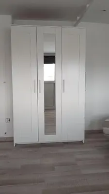 a room with white walls and a mirror at Top-Floor Studio in Glyfada Center with Sea View in Athens