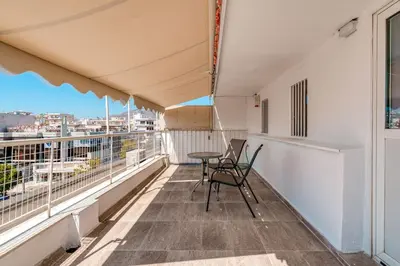 a balcony with two chairs and a table on it at Top-Floor Studio in Glyfada Center with Sea View in Athens