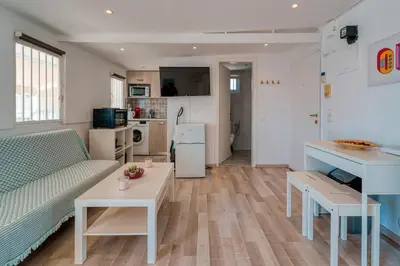 a living room with a couch and a table at Top-Floor Studio in Glyfada Center with Sea View in Athens
