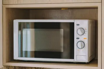a microwave oven sitting on top of a shelf at Top-Floor Studio in Glyfada Center with Sea View in Athens