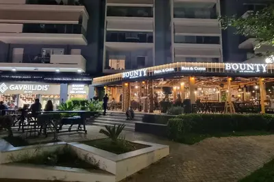 a restaurant in front of a building at night at Park View - PS4 in Piraeus