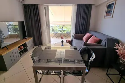 a living room with a couch and a table at Park View - PS4 in Piraeus