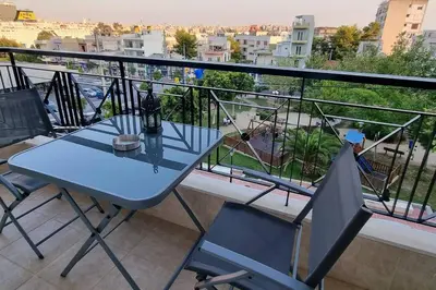 a table and chairs on a balcony with a view at Park View - PS4 in Piraeus