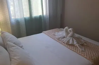 a bed with two white swans sitting on it at Katerina Holiday House in Anavissos