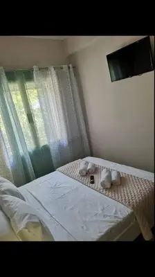 a bedroom with a bed with two stuffed animals on it at Katerina Holiday House in Anavissos
