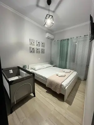 a small bedroom with a bed and a window at Katerina Holiday House in Anavissos
