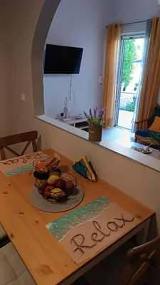 a wooden table with a bowl of fruit on it at Katerina Holiday House in Anavissos