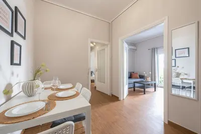 a dining room with a table with two plates on it at Comfortable Apartment In Athens in Athens