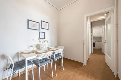 a dining room with a white table and chairs at Comfortable Apartment In Athens in Athens