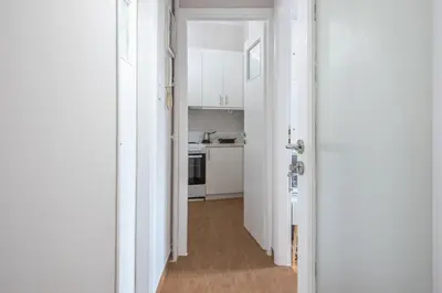 an open door to a kitchen with a hallway at Comfortable Apartment In Athens in Athens