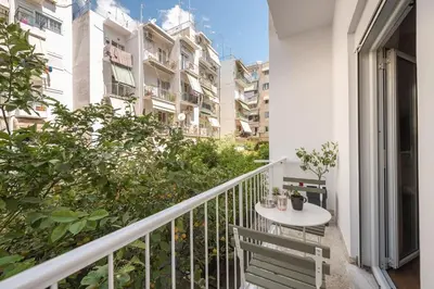a balcony with a table and a white table at Comfortable Apartment In Athens in Athens