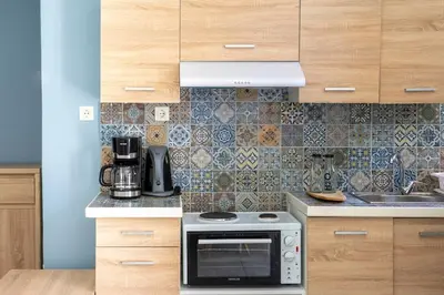 a kitchen with a stove and a sink at Private Voula Beach Suite in Athens