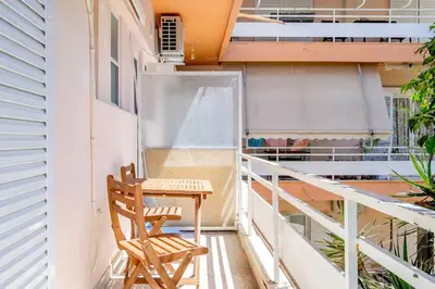 a balcony with a table and a chair at Private Voula Beach Suite in Athens