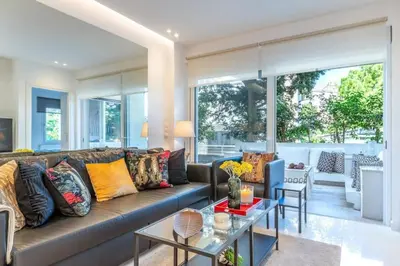 a living room with a couch and a table at Hidden Gem: 2BR Artistic Retreat in Glyfada Center in Athens