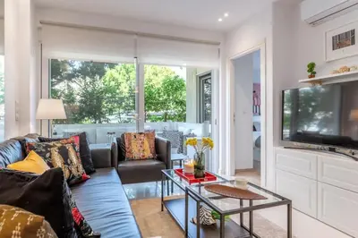 a living room with a couch and a table at Hidden Gem: 2BR Artistic Retreat in Glyfada Center in Athens