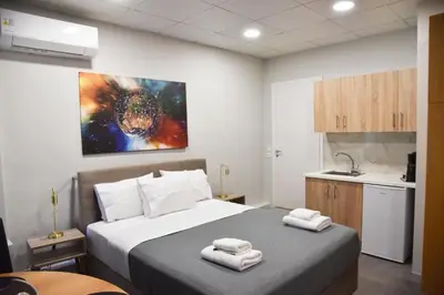 a bedroom with a bed with two towels on it at Athens Zeus A by Super Host Hub in Athens