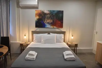 a bedroom with a bed with two towels on it at Athens Zeus A by Super Host Hub in Athens